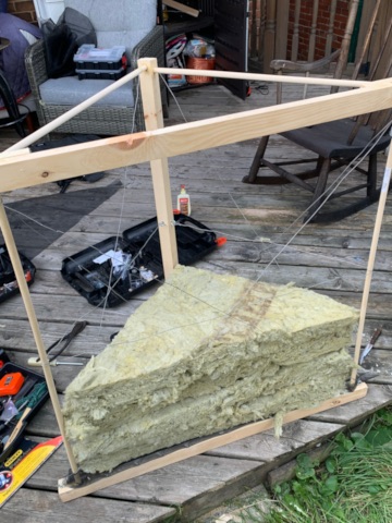 A wooden bass absorber under construction, partly filled with mineral wool. 